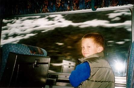 Max on the Caribou Prospector train seeing rocks and snow through his window
